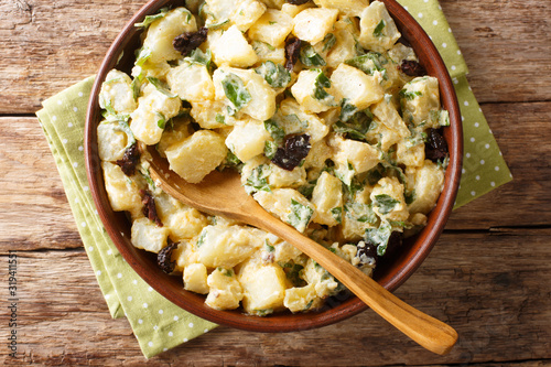 Konstfotografi Morocco cuisine potato salad with yogurt, herbs, spices and dried olives close-up in a bowl