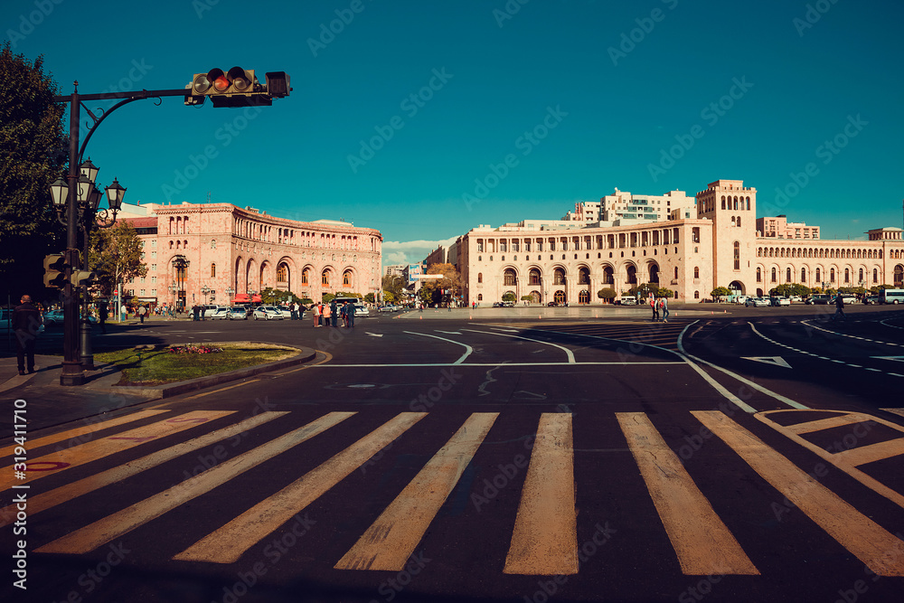 Beautiful architectural complex on Republic Square. Touristic architecture landmark. Sightseeing Yerevan. City tour. Government House. Travel to Armenia. Tourism concept. Sunny day. Focus on crosswalk
