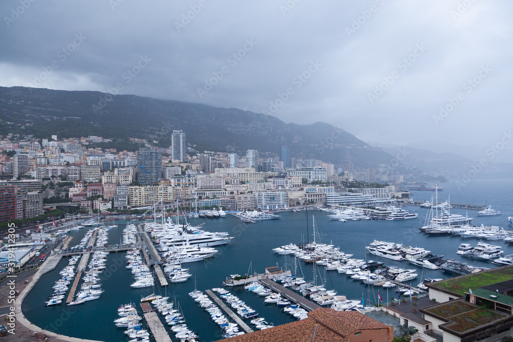 Monaco bay with lot of boats on a rainy day.