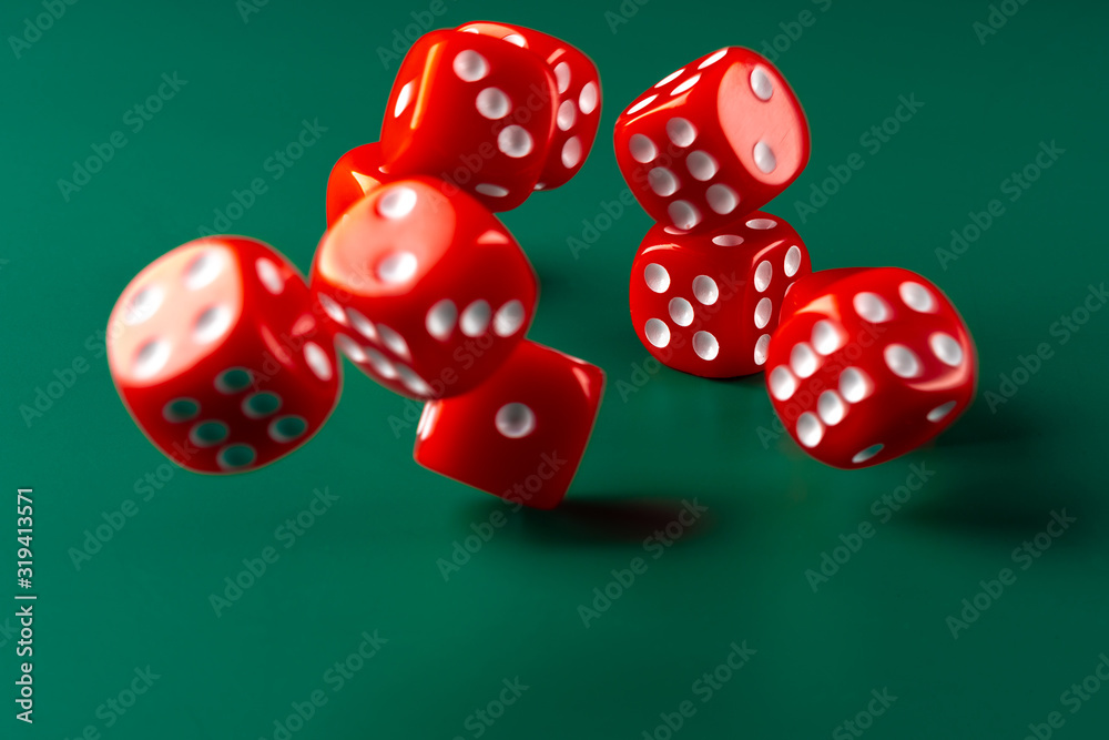 Red dice on green background close up Red dice on green background close up