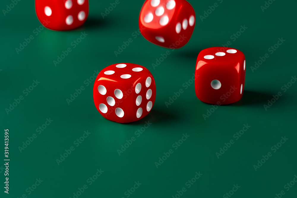 Red dice on green background close up Red dice on green background close up