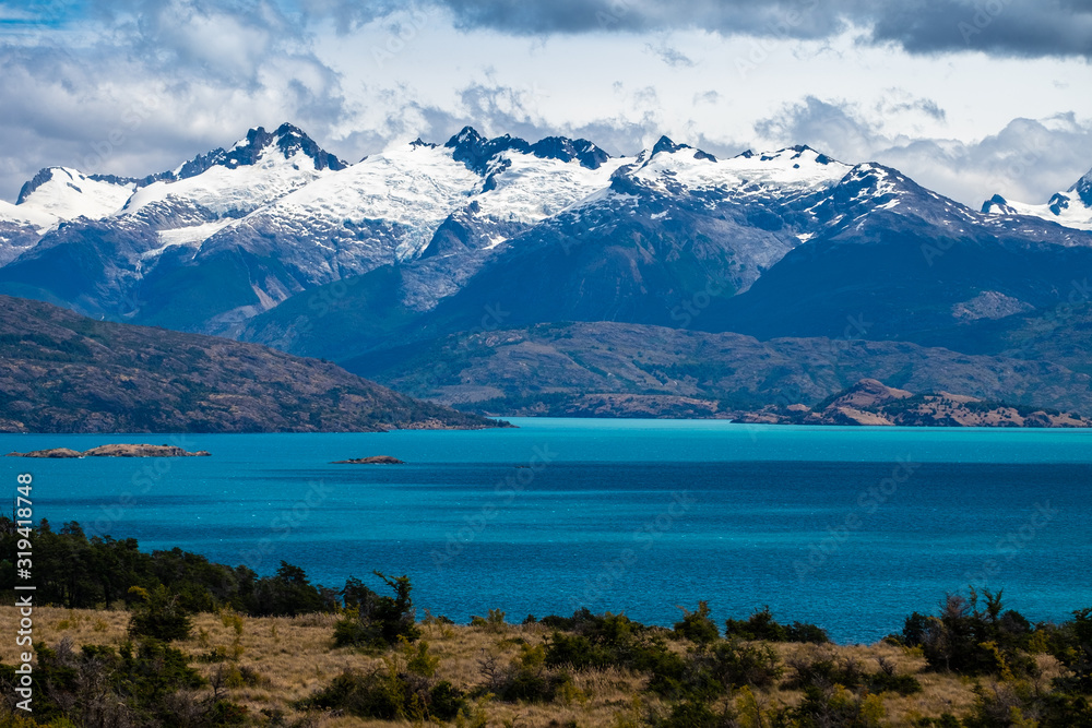 Snow capped mountains Snow capped mountains and blue lake of General Carrera in Chilean Patagoniaand blue lake