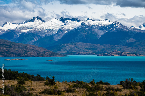 Snow capped mountains Snow capped mountains and blue lake of General Carrera in Chilean Patagoniaand blue lake