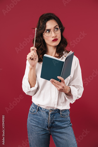 Thinking young woman in glasses