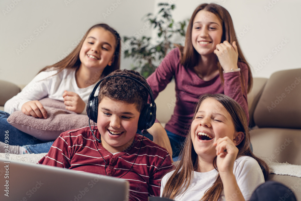 Laughing friends watching funny video on laptop Laughing friends watching funny video on laptop