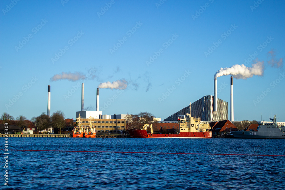 Large ships moored at the incinerator. Beautiful sunny weather in winter in Copenhagen city