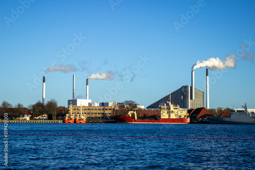 Large ships moored at the incinerator. Beautiful sunny weather in winter in Copenhagen city