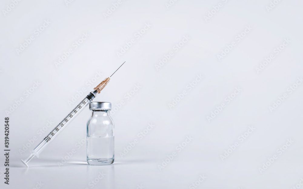 syringe and glass vial with medicine for injection close-up, copy space