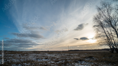 Beautiful setting sun over frozen field