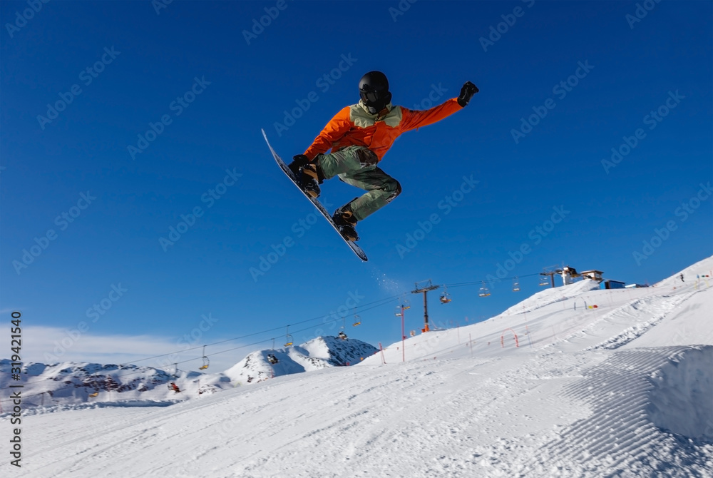 Snowboarder does a jumping trick in the snow Park
