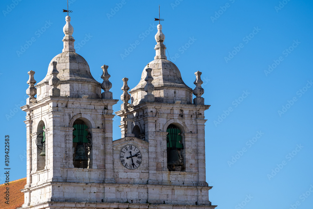 Sanctuary of Our Lady (Santuario de Nossa Senhora) church against blue sky in Nazare, Portugal