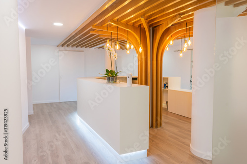 Reception of modern office with lights and wood on the ceiling