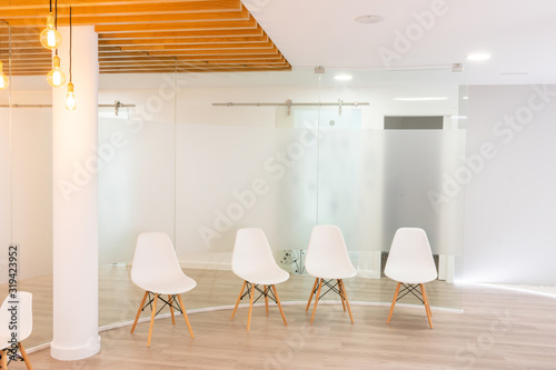 white waiting room lit with empty chairs