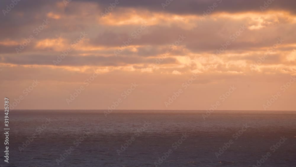 Scenic view of swirling sea with burning sunset sky in the background. Majestic sunrise view with burning sky, nobody