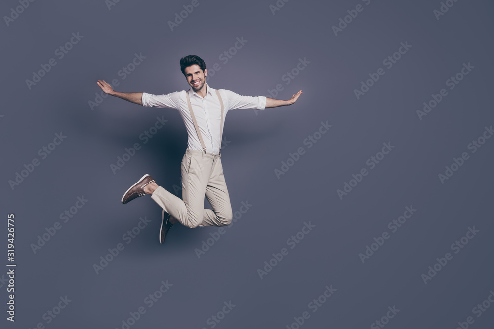 Full length photo of cheerful attractive guy jump have date with lovely girl fooling imagine he fly plane wear modern clothing isolated over grey color background