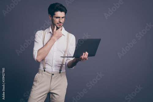 Portrait of minded pensive company owner man work computer think thoughts decide difficult start-up questions wear stylish outfit isolated over grey color background