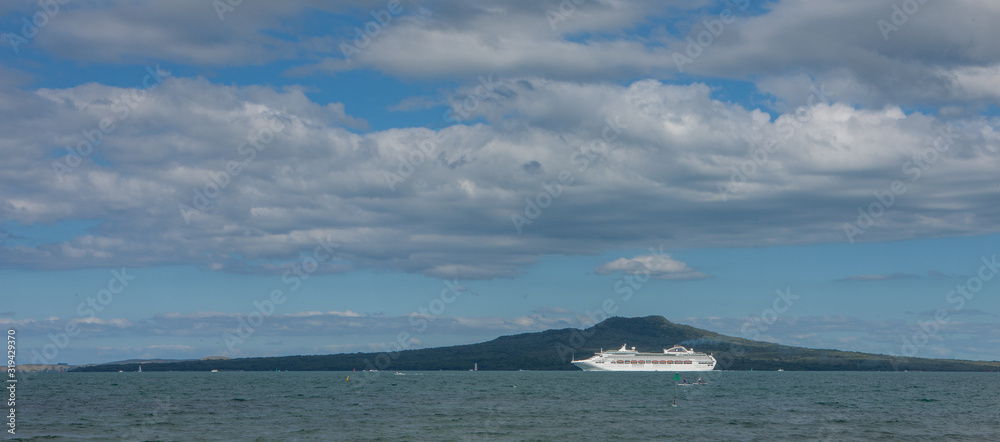 Cruiseship at sea with Rangitoto island. Volcano. New Zealand. Auckland coast. Cruiseship at sea with Rangitoto island. Volcano. New Zealand. Auckland coast.
