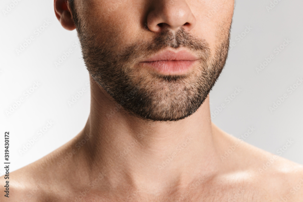 Cropped photo of unshaven half-naked man posing at camera Cropped photo of unshaven half-naked man posing at camera