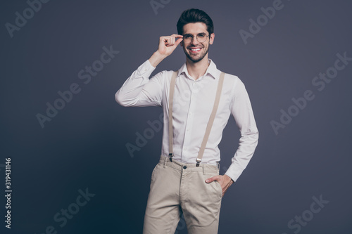 Portrait of nice attractive professional imposing cheerful cheery content brunet guy finance real estate agent broker company owner touching specs isolated on grey pastel color background
