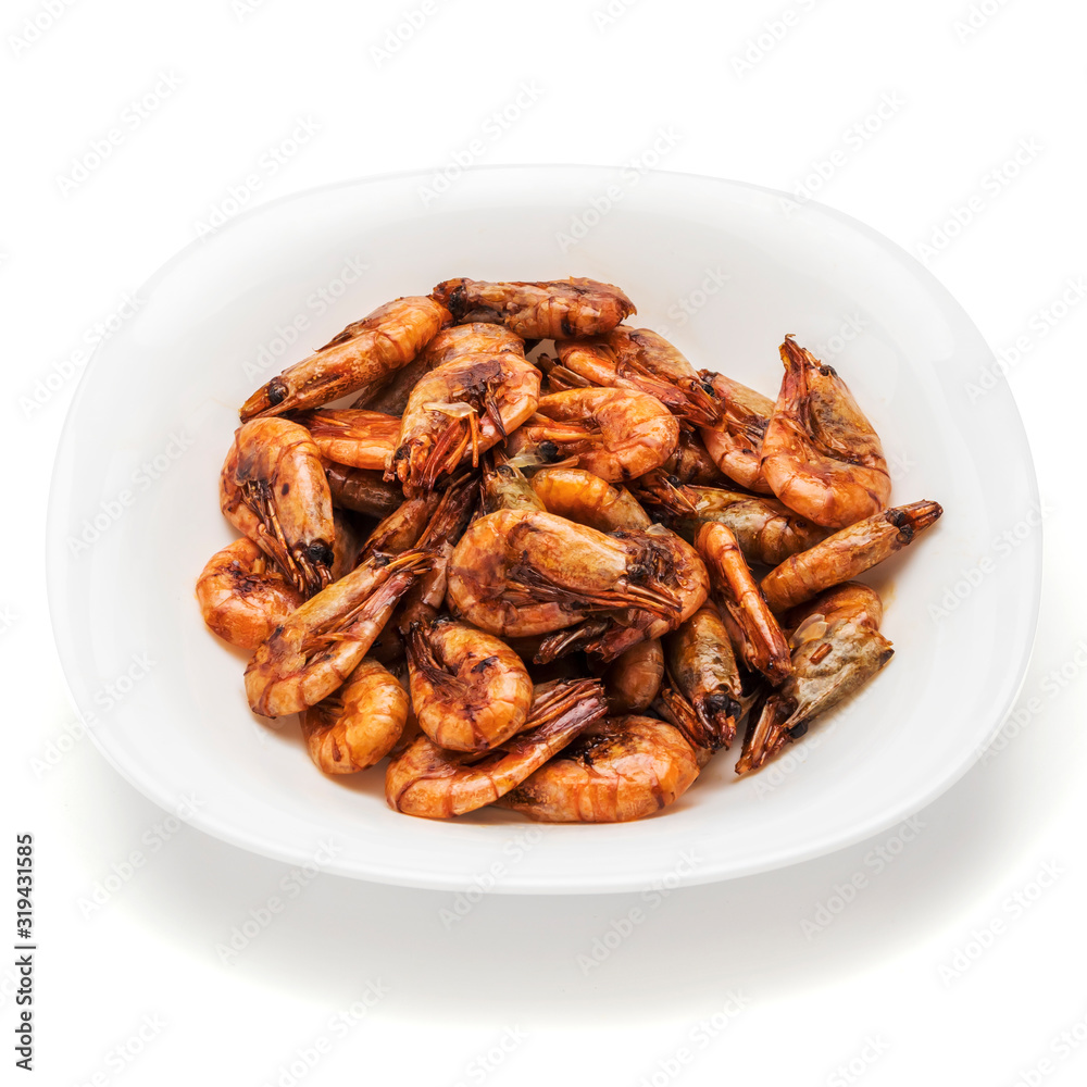 shrimp fried in soy sauce on a white plate isolate