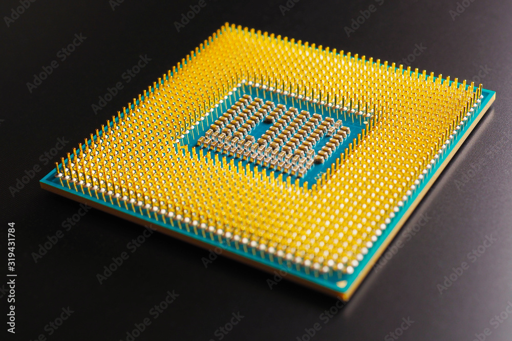 Processor microprocessor CPU of a computer or laptop lies on a dark matte surface. Close-up. Semiconductors, pins and connectors. IT. Illustration: electronic and computing equipment. Macro Processor microprocessor CPU of a computer or laptop lies on a dark matte surface. Close-up. Semiconductors, pins and connectors. IT. Illustration: electronic and computing equipment. Macro