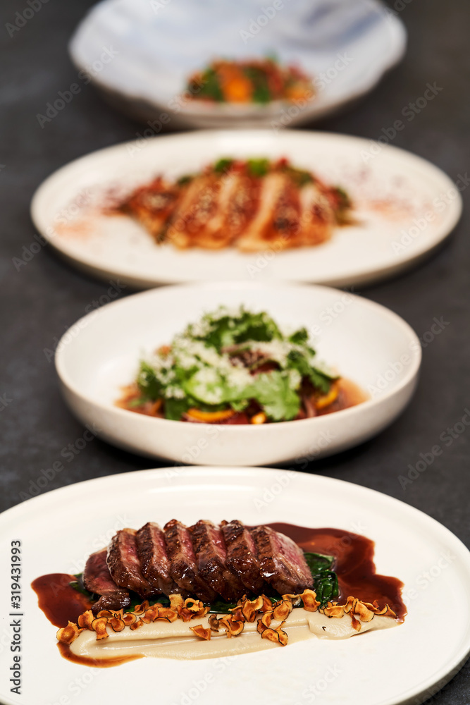 Set of various plates of food on a gray table background with copy space Set of various plates of food on a gray table background with copy space
