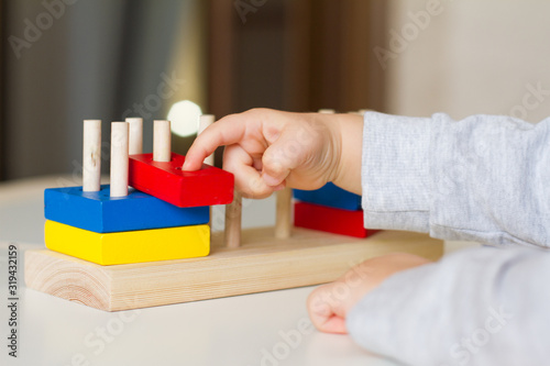 Toy made of wood for the study of shapes and colors. Useful game for a child on a white table. Montessori Education. Materials for the school. Materials on geometry. the concept of teaching children.