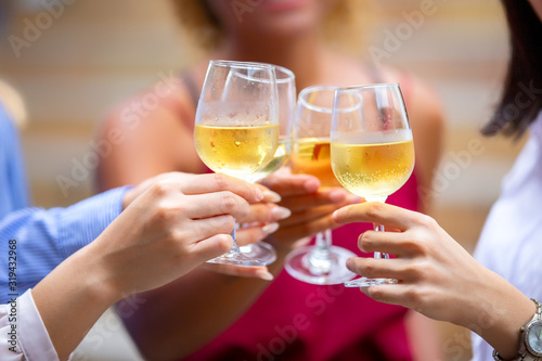 Close up on hand with wine glasses cheerful on party