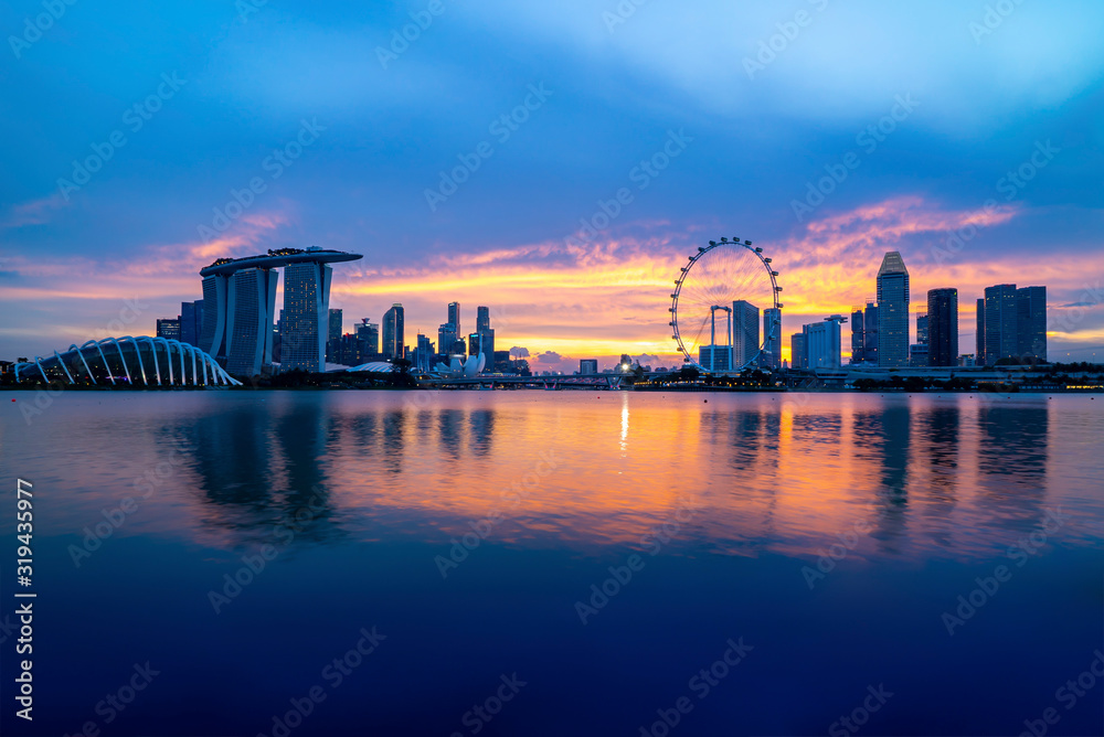 Singapore landmark city skyline at the Marina bay during sunset dusk.