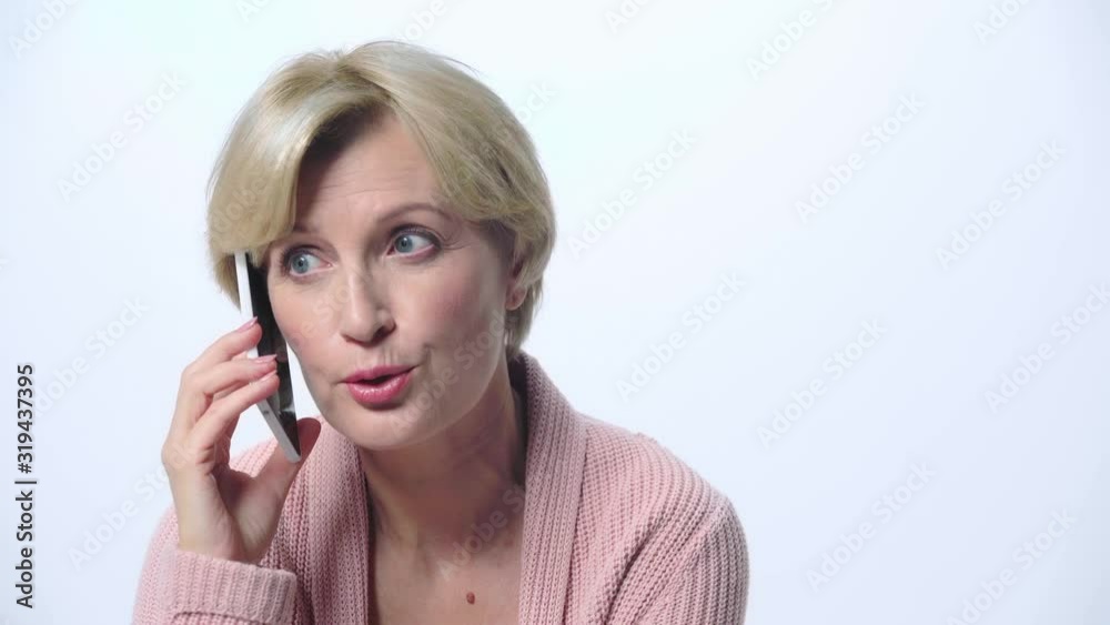 mature woman talking on smartphone isolated on white mature woman talking on smartphone isolated on white