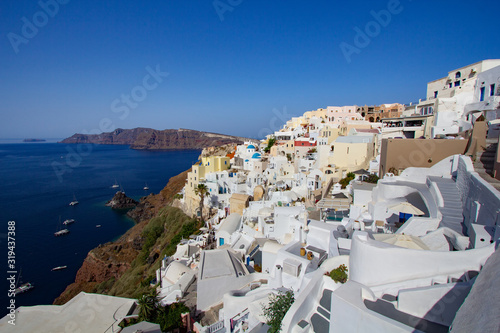 Fototapeta Naklejka Na Ścianę i Meble -  Blue and white colours of Oia City. Magnificent panorama of the island of Santorini Greece during a beautiful sunset in the Mediterranean. Love and travel background