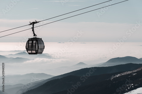 Cable car cabin above the couds during winter inversion weather