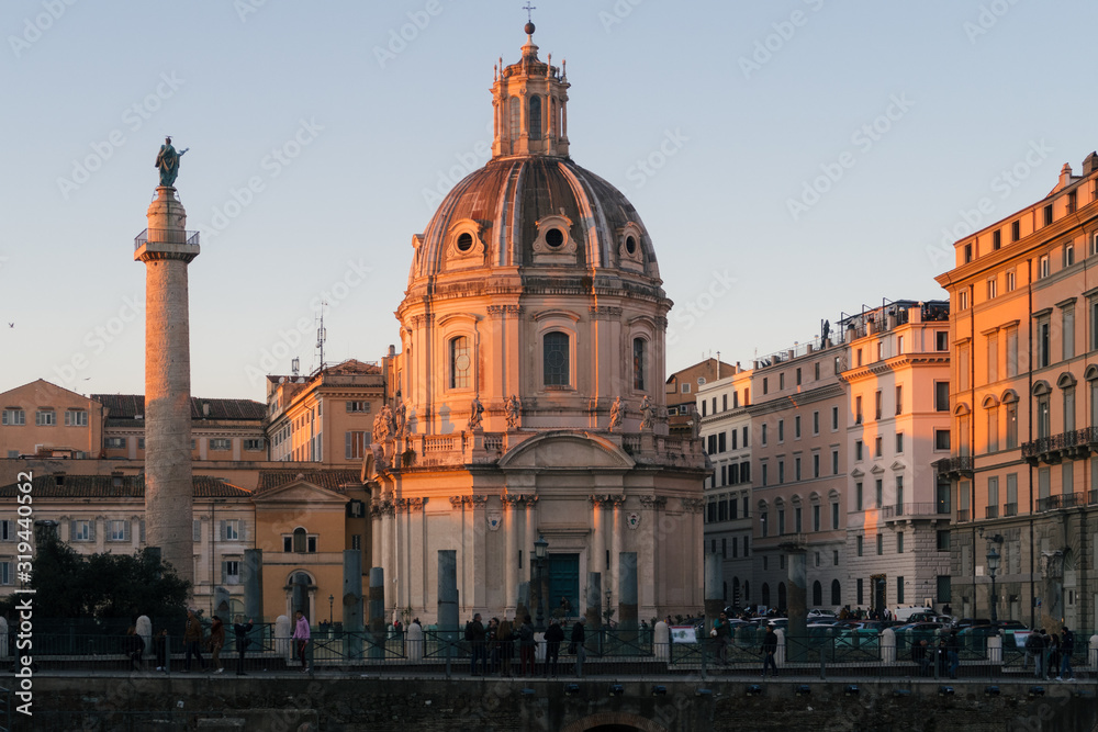 Obraz premium Rome, Italy - Jan 1, 2020: View across the ancient ruins of Trajan's Forum towards Trajan's Column and the Santa Maria di Loreto church in Rome, Italy