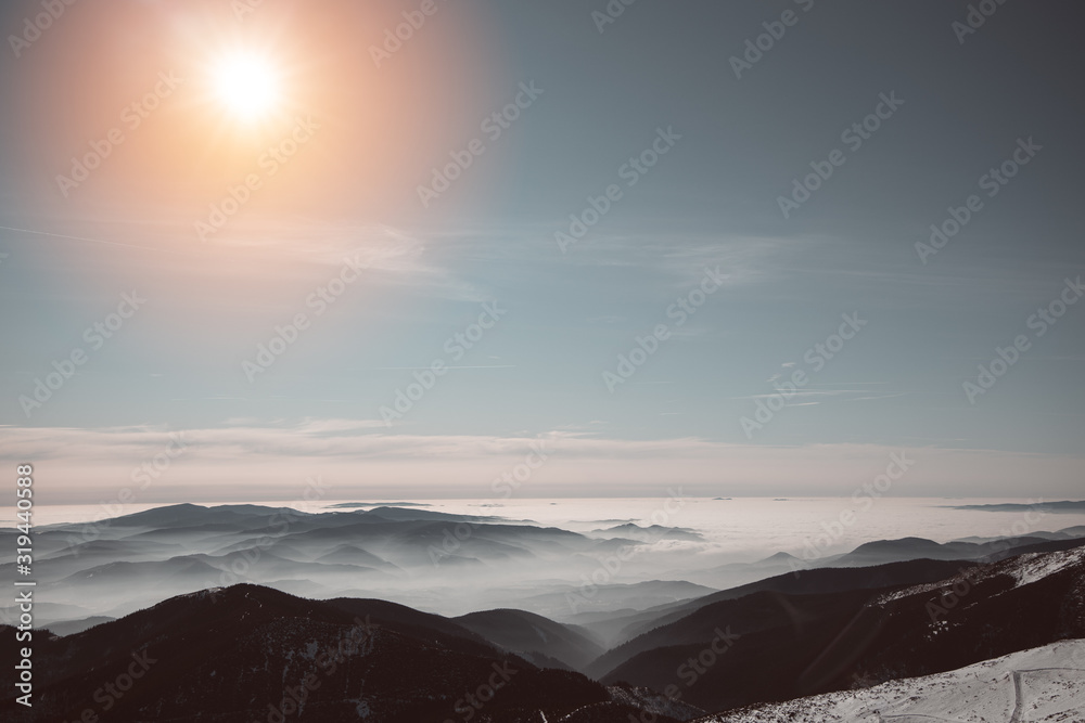 Winter sunset above clouds during inversion weather