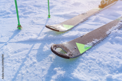 Detail of modern skis and poles with an hole on the front of the skis photo