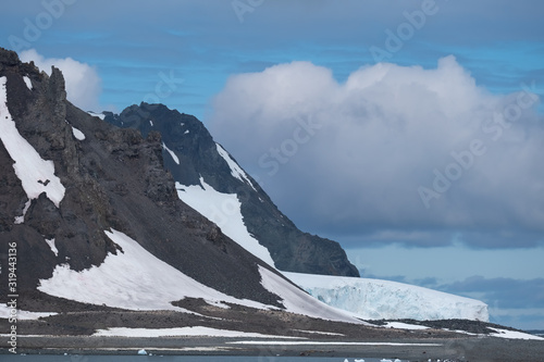 Breathtaking antarctic scenery with  penguins and elephant seals in the foreground, Yankee Harbour, South Shetland Islands, Antarctica photo