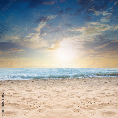 Empty sand beach in front of summer sea with copy space