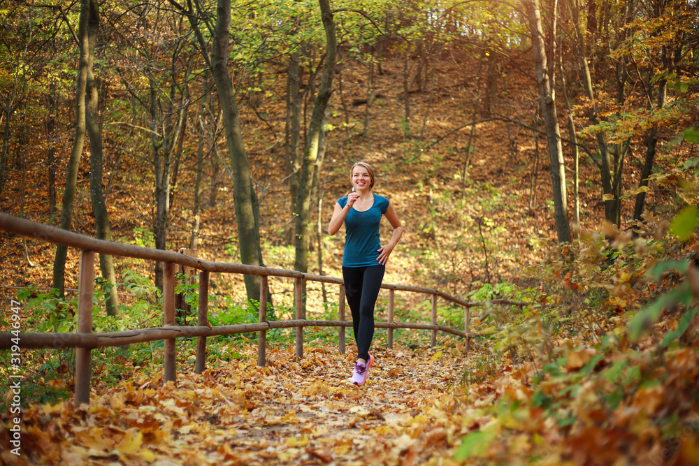 Young slender woman runs in forest park, healthy lifestyle outdoors in nature Young slender woman runs in forest park, healthy lifestyle outdoors in nature