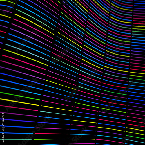 Seamless horizontal neon color striped pattern. Print neon shining at the rainbow room. Ink paint brush line with torn paper effect on black background. Modern material style in green, purple, pink.