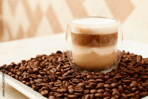 A cup of coffee in coffee beans. Coffee background