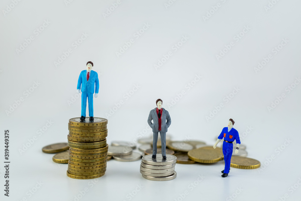 Miniature people: small businessmen and a worker standing on stack of coins with some coins laying behind them on a white backround. Money, Financial, Business Growth concept. Miniature people: small businessmen and a worker standing on stack of coins with some coins laying behind them on a white backround. Money, Financial, Business Growth concept.