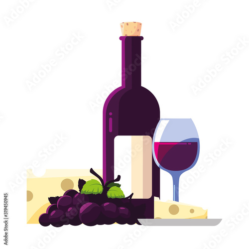 bottle and glass of wine with piece of cheese and grapes