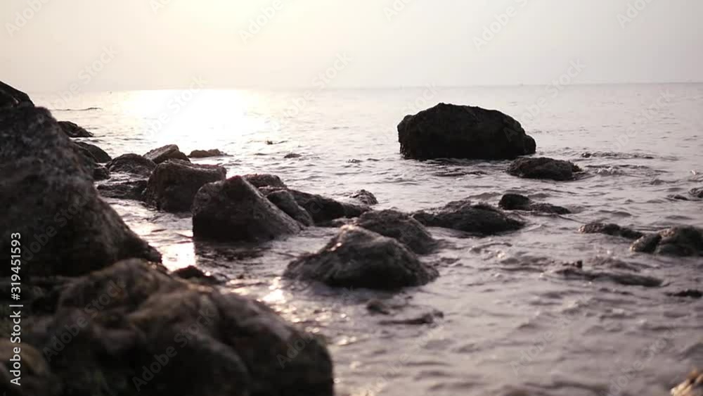 beautiful sunset on the sea on the horizon with silhouettes of stones and rocks beautiful sunset on the sea on the horizon with silhouettes of stones and rocks