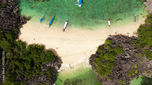 Fotografie Beautiful tropical beach with tourists and boats, aerial drone