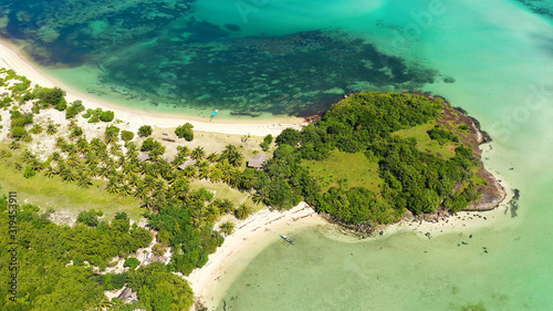 A lagoon with a coral reef and a white sandy beach, a view from above. The coast of a tropical island. Summer and travel vacation concept. Caramoan Islands, Philippines. photo