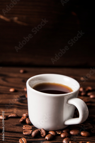 Cup of hot fresh black coffee on vintage wooden table