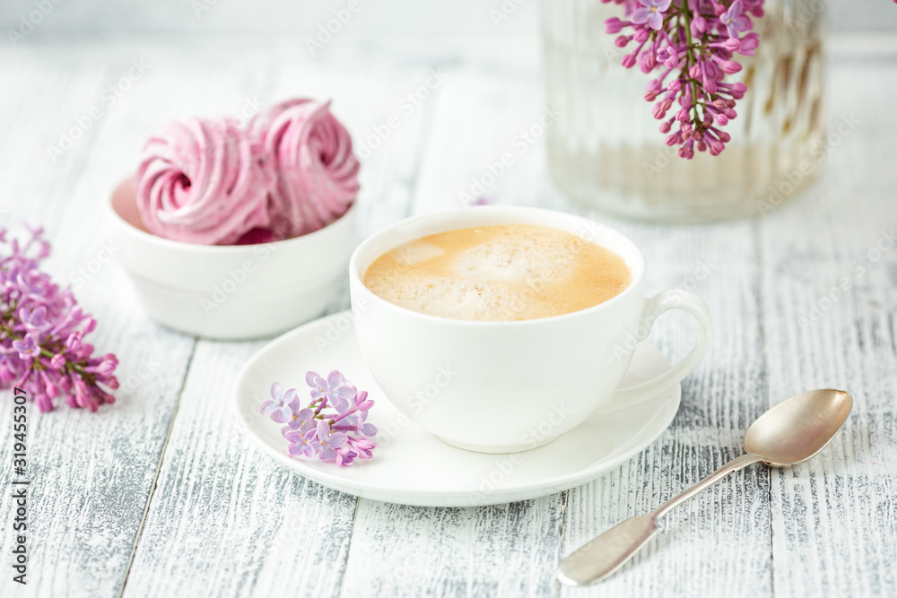 Bouquet of lilacs, cup of coffee, homemade marshmallow Romantic spring morning Selective focus Bouquet of lilacs, cup of coffee, homemade marshmallow Romantic spring morning Selective focus