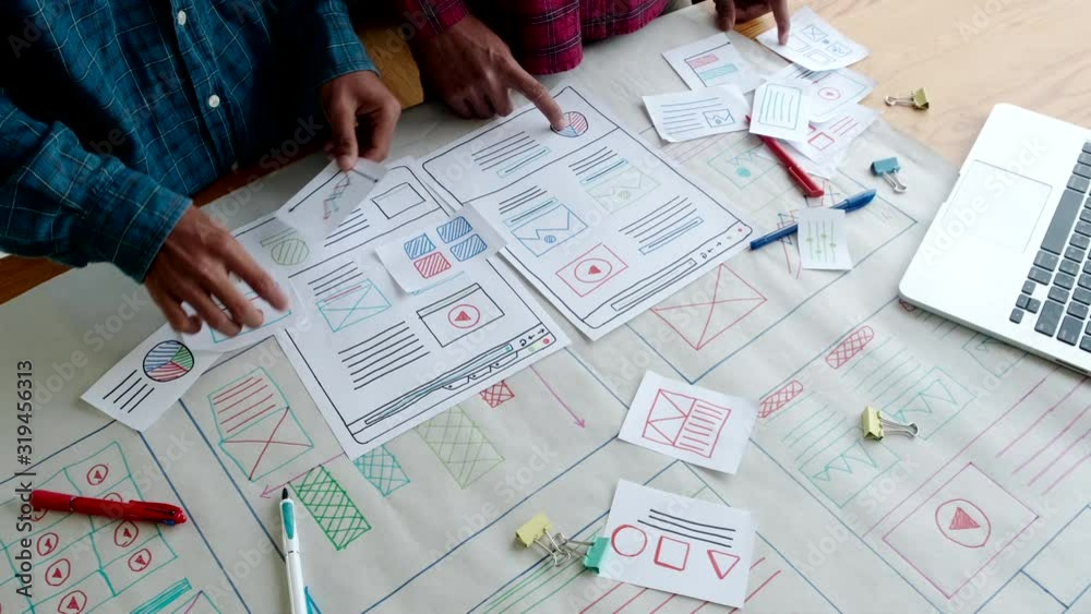 Web designer working laptop responsive design. Creative UI Ux designer teamwork meeting planning designing wireframe layout application development for smartphone screen mobile phone technology