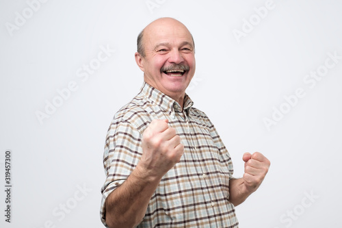 Фотография Middle age man happy and excited celebrating victory expressing big success