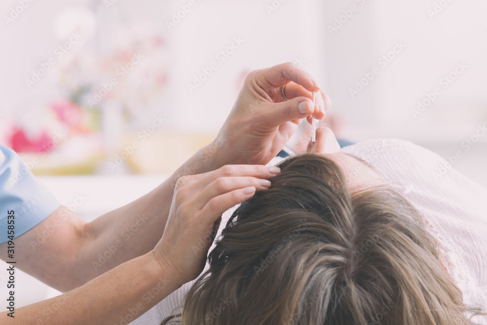 Fototapeta premium Therapist applying acupuncture needle
